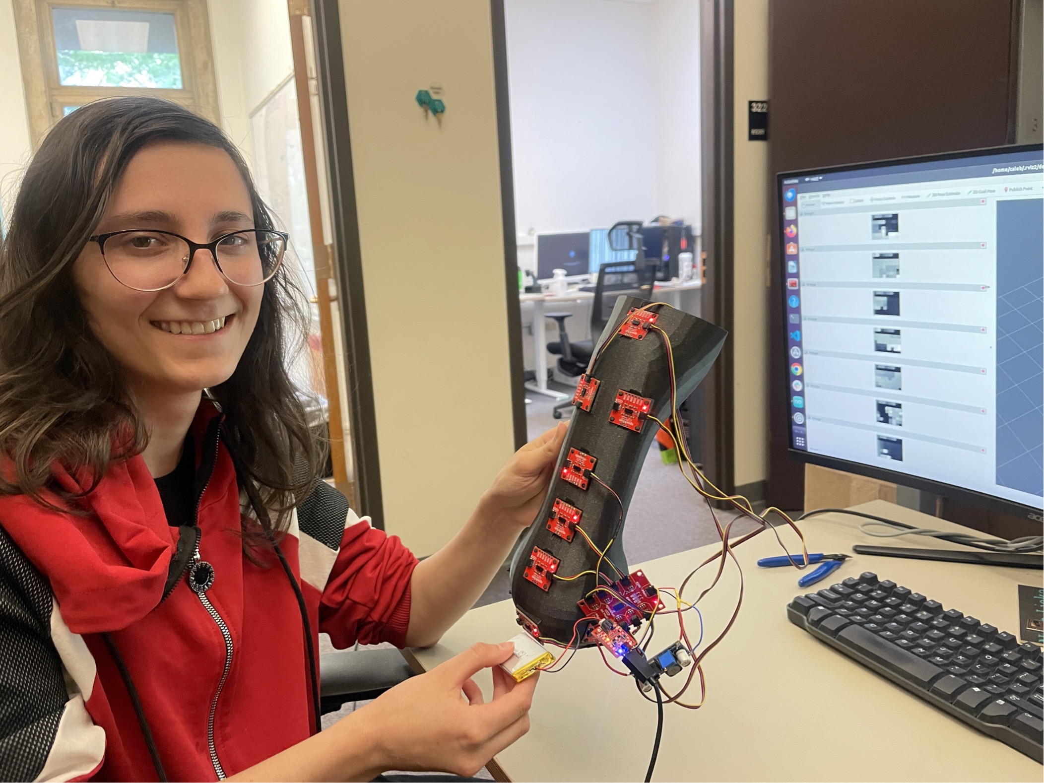 Anna Soukhovei holding a 3D-printed sensor skin