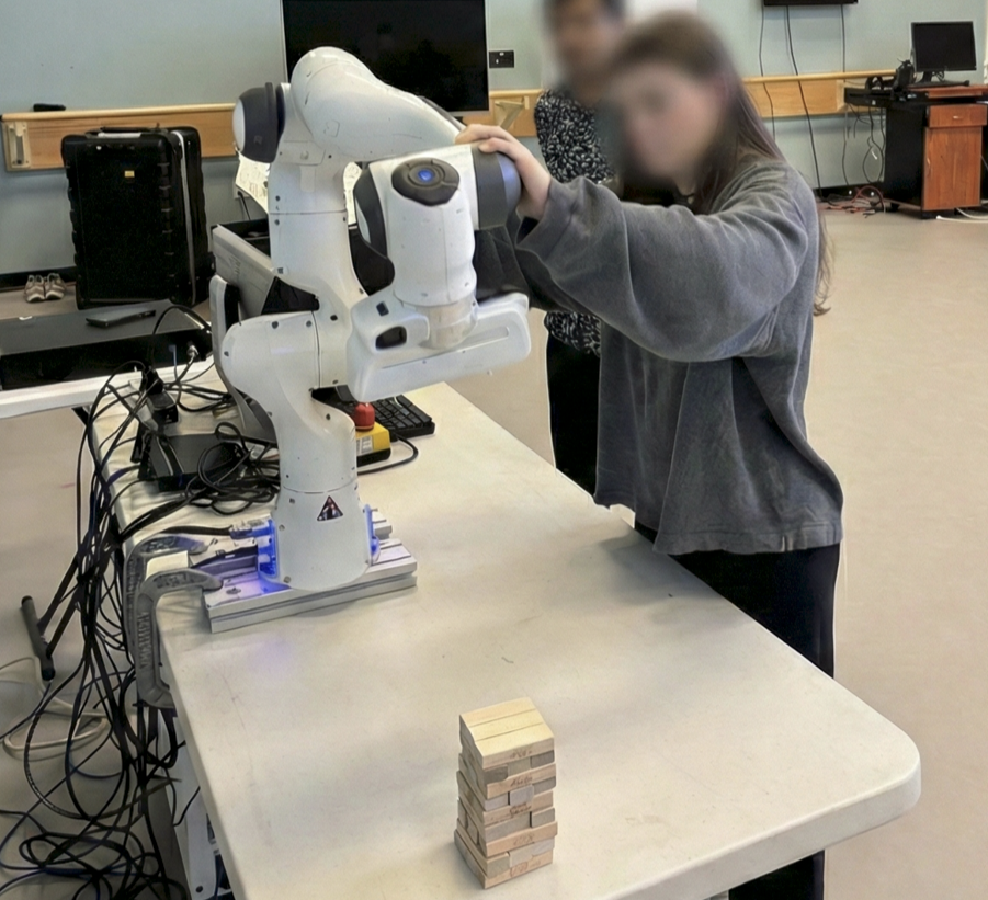 Dancer performing kinesthetic teaching on Franka robot